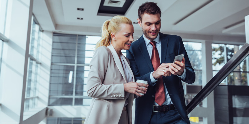 Business security male female looking at phone 01